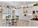 Bright kitchen with white cabinets, granite counters, and breakfast nook at 16005 Cape Coral Dr, Wimauma, FL 33598