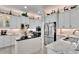 Modern kitchen with large island, white cabinetry, and granite countertops at 16005 Cape Coral Dr, Wimauma, FL 33598