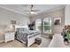 Spacious bedroom with ceiling fan, large windows, and white furniture at 16005 Cape Coral Dr, Wimauma, FL 33598