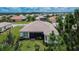 Aerial view of a home with a large backyard and screened patio at 16005 Cape Coral Dr, Wimauma, FL 33598