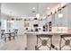 Modern kitchen with white cabinets, granite countertops, and breakfast bar at 16005 Cape Coral Dr, Wimauma, FL 33598