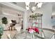 Elegant dining room with glass table, chandelier, and view into living room at 16005 Cape Coral Dr, Wimauma, FL 33598