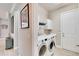 Convenient laundry room with washer, dryer, and storage cabinets at 16005 Cape Coral Dr, Wimauma, FL 33598
