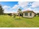 Spacious backyard with lush green grass and landscaping at 16005 Cape Coral Dr, Wimauma, FL 33598
