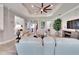 Open living room with fireplace and view of kitchen and entryway at 16005 Cape Coral Dr, Wimauma, FL 33598
