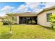 Spacious backyard with screened patio and lush lawn at 16005 Cape Coral Dr, Wimauma, FL 33598