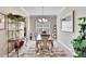 Bright dining room features a glass-top table and decorative shelving at 16005 Cape Coral Dr, Wimauma, FL 33598