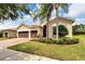 Single-Gathering home with two-car garage and landscaped yard at 16005 Cape Coral Dr, Wimauma, FL 33598