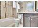Bathroom with toilet, tub, and dark vanity at 16005 Cape Coral Dr, Wimauma, FL 33598