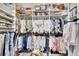 Organized walk-in closet with shelves and hanging rods at 16005 Cape Coral Dr, Wimauma, FL 33598