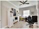 Home office with built-in shelving and comfortable seating at 16005 Cape Coral Dr, Wimauma, FL 33598