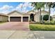 Two-story home with a two-car garage and well-manicured lawn at 16005 Cape Coral Dr, Wimauma, FL 33598