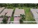 Aerial view of a home with a two-car garage and landscaping at 16005 Cape Coral Dr, Wimauma, FL 33598