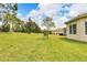 Spacious backyard with grassy area, providing ample outdoor space at 16005 Cape Coral Dr, Wimauma, FL 33598