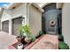 Brick walkway leading to the front door with lush landscaping at 16005 Cape Coral Dr, Wimauma, FL 33598