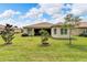 Spacious backyard with lush lawn and mature trees at 16005 Cape Coral Dr, Wimauma, FL 33598