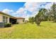 Spacious backyard with lush lawn and mature trees at 16005 Cape Coral Dr, Wimauma, FL 33598