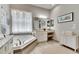 Elegant bathroom with soaking tub, vanity, and stylish decor at 16005 Cape Coral Dr, Wimauma, FL 33598