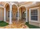 Elegant entryway with columns and a tiled patio at 17914 Burnt Oak Ln, Lithia, FL 33547