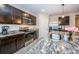 Modern kitchen with dark cabinetry, granite countertops, and stainless steel appliances at 8367 Ender Hills Dr, Wesley Chapel, FL 33545