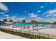 Expansive sandy beach with numerous lounge chairs and palm trees at 8367 Ender Hills Dr, Wesley Chapel, FL 33545