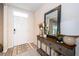 Inviting entryway with a console table, mirror, and stylish decor at 8367 Ender Hills Dr, Wesley Chapel, FL 33545
