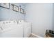 Laundry room with washer, dryer, and shelving at 8367 Ender Hills Dr, Wesley Chapel, FL 33545