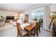 Dining area with wooden table and view into living room at 8367 Ender Hills Dr, Wesley Chapel, FL 33545