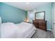 Light teal bedroom with a dresser and a bed at 8367 Ender Hills Dr, Wesley Chapel, FL 33545