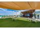 Artificial turf lawn with tables and chairs near an outdoor stage at 8367 Ender Hills Dr, Wesley Chapel, FL 33545