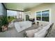 Spacious covered patio with comfortable seating and a grill at 8367 Ender Hills Dr, Wesley Chapel, FL 33545