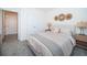 Bright bedroom with a queen bed, double doors, and carpet flooring at 8367 Ender Hills Dr, Wesley Chapel, FL 33545