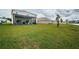Spacious backyard with covered patio and lush green lawn at 8367 Ender Hills Dr, Wesley Chapel, FL 33545