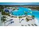 Drone view of crystal-clear lagoon, beach area, and water features at 8367 Ender Hills Dr, Wesley Chapel, FL 33545