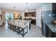 Modern kitchen with dark cabinetry, granite countertops, and stainless steel appliances at 8367 Ender Hills Dr, Wesley Chapel, FL 33545
