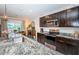 Modern kitchen with an island, granite countertops, and stainless steel appliances at 8367 Ender Hills Dr, Wesley Chapel, FL 33545