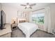Bedroom with a bed, nightstand, and large window at 8367 Ender Hills Dr, Wesley Chapel, FL 33545