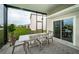 Covered patio with table and chairs, offering a shaded outdoor space at 8367 Ender Hills Dr, Wesley Chapel, FL 33545