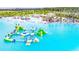 Aerial view of resort-style pool with expansive lagoon, waterslide, and sandy beach at 8367 Ender Hills Dr, Wesley Chapel, FL 33545