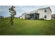 Landscaped backyard showcasing a home with a covered patio at 8367 Ender Hills Dr, Wesley Chapel, FL 33545