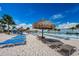 Beach area with numerous lounge chairs under thatched umbrellas at 8367 Ender Hills Dr, Wesley Chapel, FL 33545