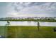 Community view showcasing houses and a pond at 8367 Ender Hills Dr, Wesley Chapel, FL 33545