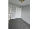 Spacious bedroom with grey carpet and double door closet at 36131 Pine Bluff Loop, Dade City, FL 33525