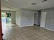 Open living room with tiled floors and access to other rooms at 36131 Pine Bluff Loop, Dade City, FL 33525
