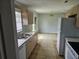 Kitchen with beige cabinets, tile floors, and stainless steel appliances at 36131 Pine Bluff Loop, Dade City, FL 33525