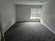 Spacious bedroom with gray walls and carpet at 36131 Pine Bluff Loop, Dade City, FL 33525