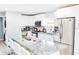 Modern kitchen with stainless steel appliances, white cabinets, and granite countertops at 8114 N Edison Ave, Tampa, FL 33604