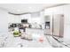 Modern kitchen with stainless steel appliances, white cabinets, and granite countertops at 8114 N Edison Ave, Tampa, FL 33604