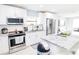 Modern kitchen with stainless steel appliances, white cabinets, and granite countertops at 8114 N Edison Ave, Tampa, FL 33604