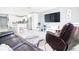 Open concept living room with a large TV, leather furniture, and kitchen views at 8114 N Edison Ave, Tampa, FL 33604